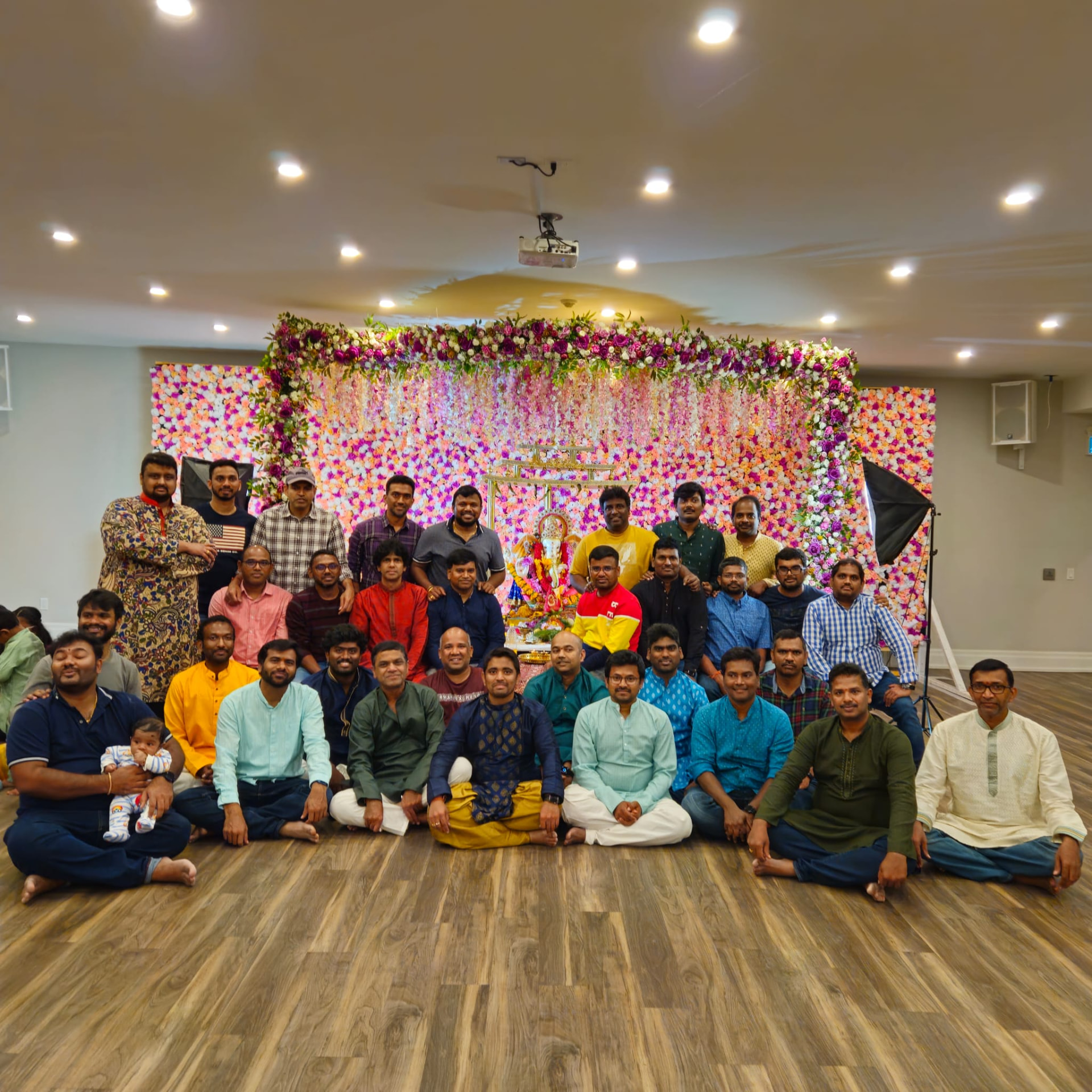 Community members presenting a traditional offering at the Ganesh mandap, 2024